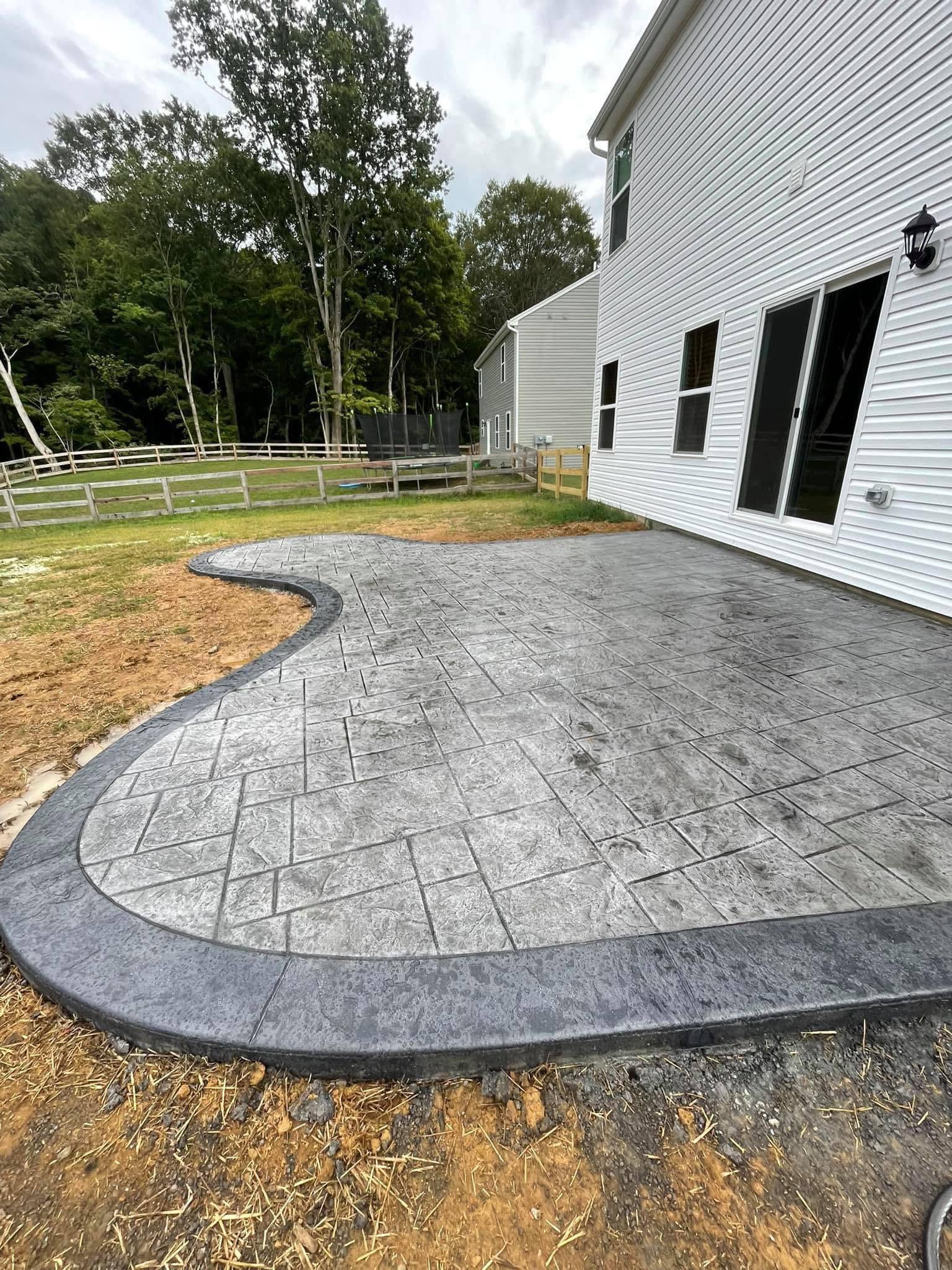 Stamped concrete patio with a curved decorative border